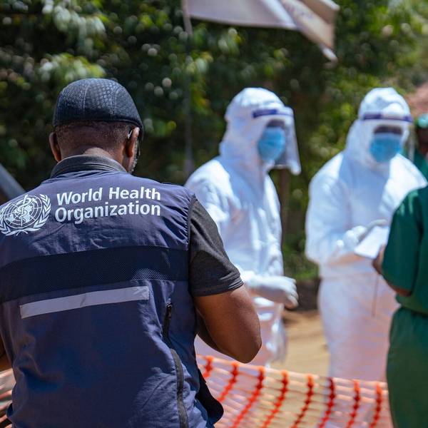WHO worker and healthcare providers in PPE respond to Ebola outbreak in Congo