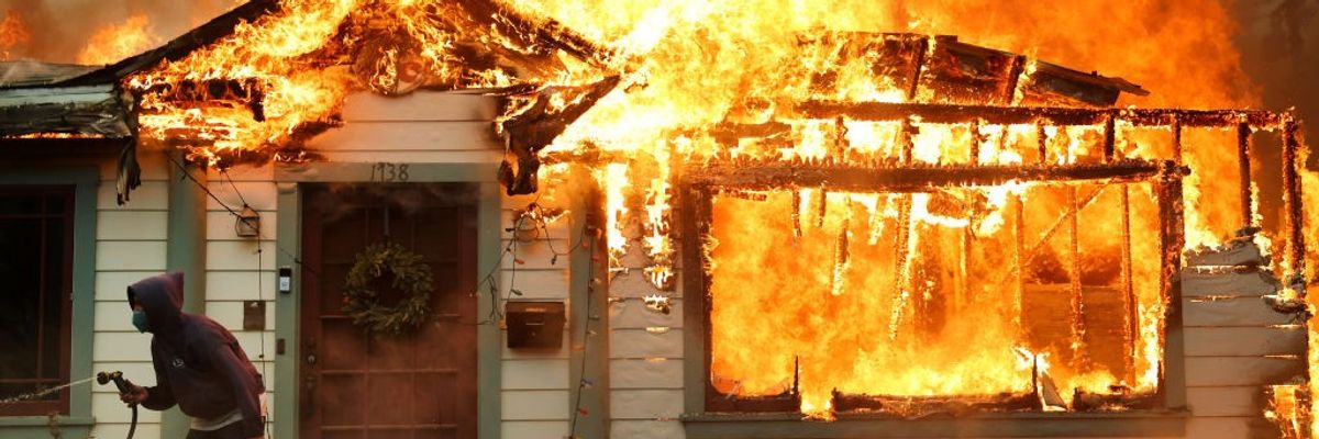 Wildfire burns a house.