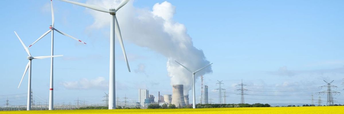 wind turbines next to coal-fired plant