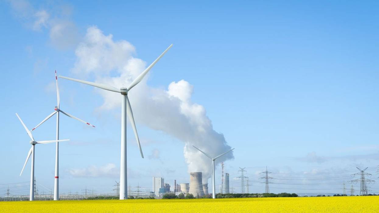 wind turbines next to coal-fired plant