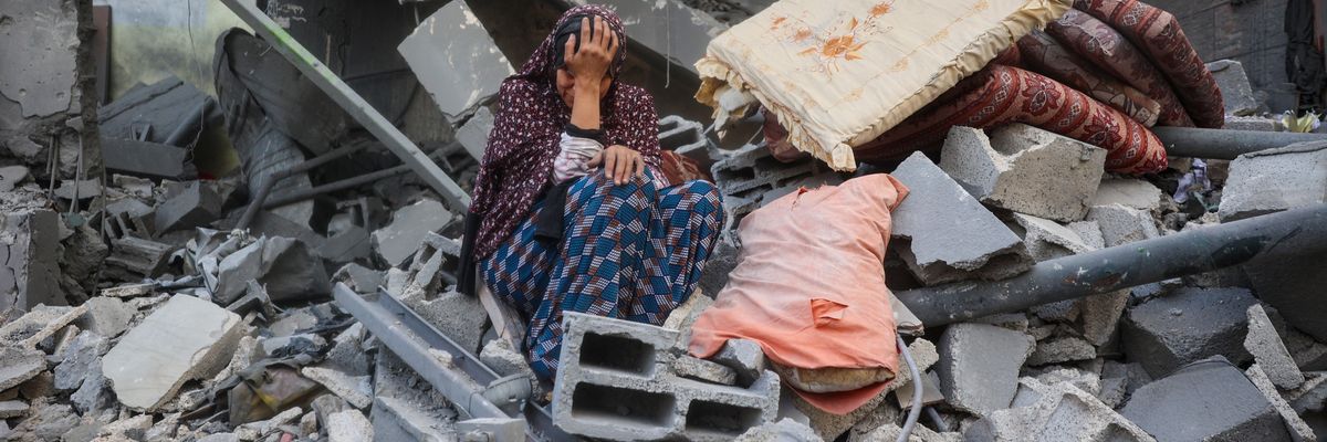 Woman. cries in rubble in Gaza.