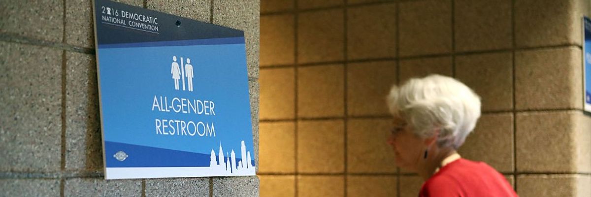 Woman entering an All-Gender Restroom