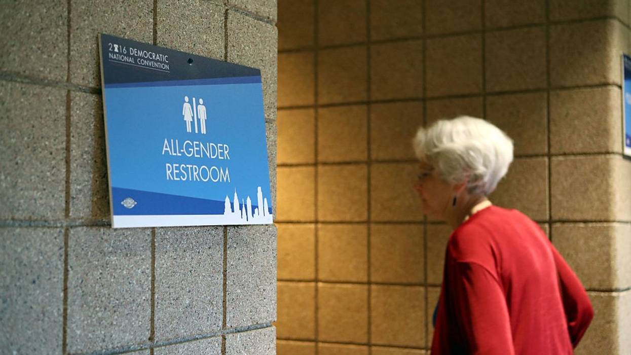Woman entering an All-Gender Restroom