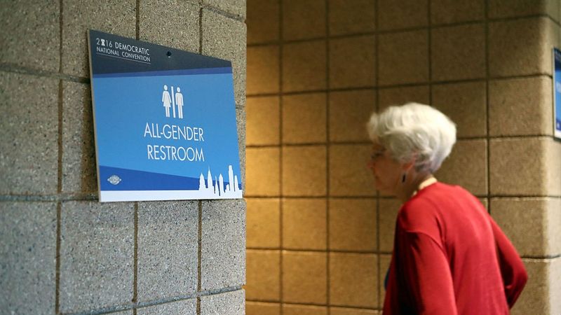 Woman entering an All-Gender Restroom