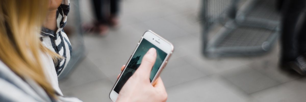woman holding cell phone