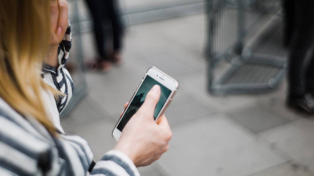 woman holding cell phone