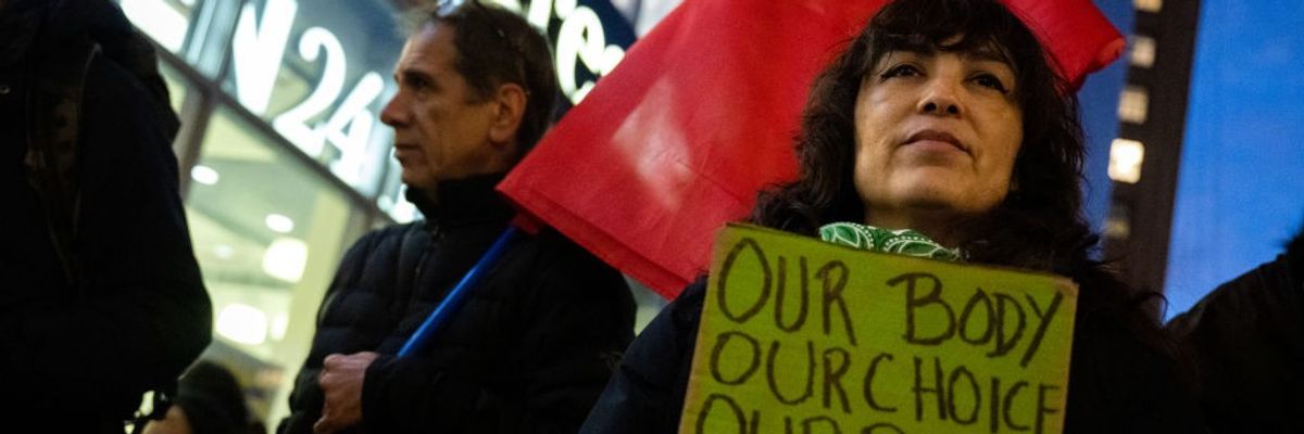 Woman holding sign: "Our Body, Our Choice"