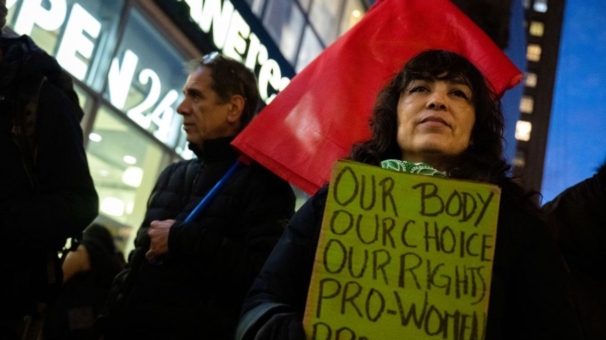 Woman holding sign: "Our Body, Our Choice"