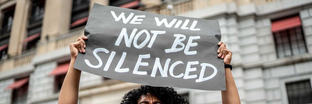 Woman holding signs during on a demonstration outdoors