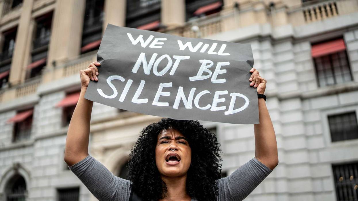 Woman holding signs during on a demonstration outdoors