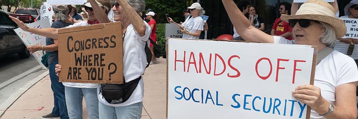 Woman holds sign reading, "Hands off social security."