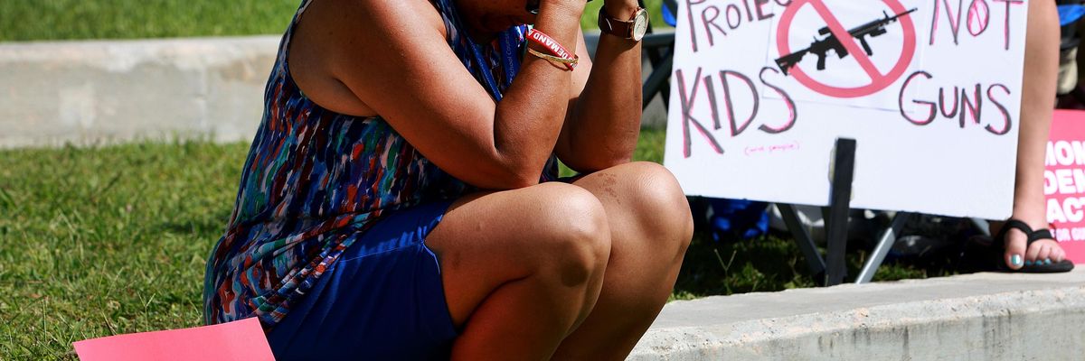 Woman mourns victims of gun violence