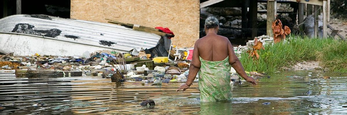 Woman wades through waters in Funafuti Atoll