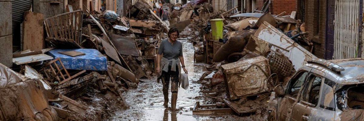 Woman walks through Flood debris in Spain