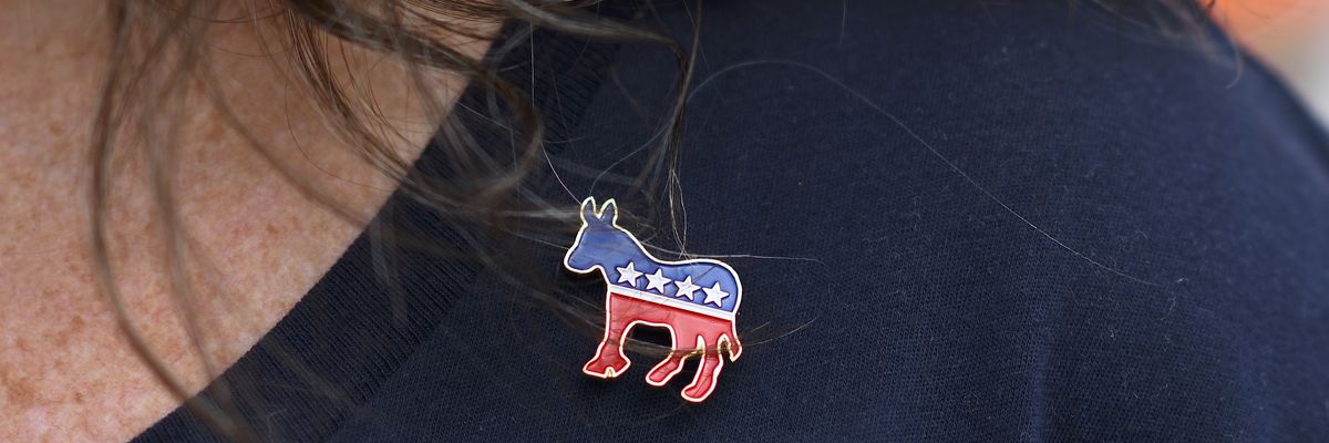 Woman wearing Democratic Party pin.