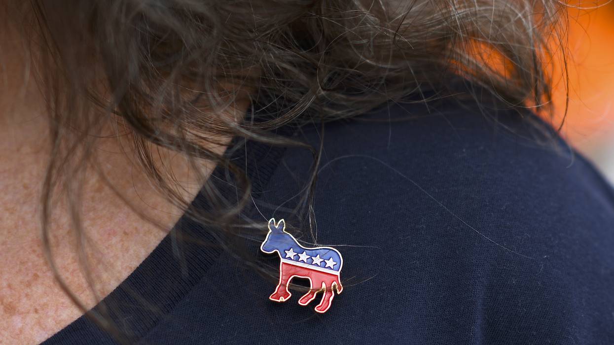 Woman wearing Democratic Party pin.