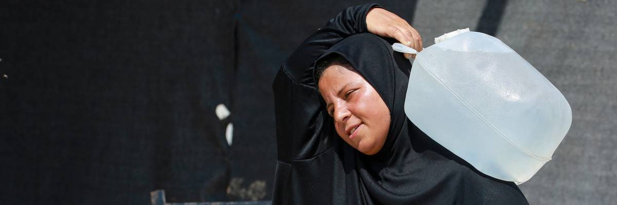 Woman with water in Gaza.