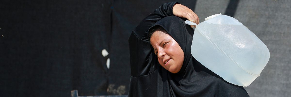 Woman with water in Gaza.