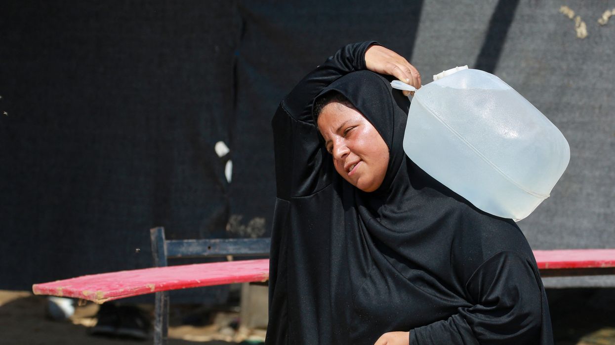 Woman with water in Gaza.