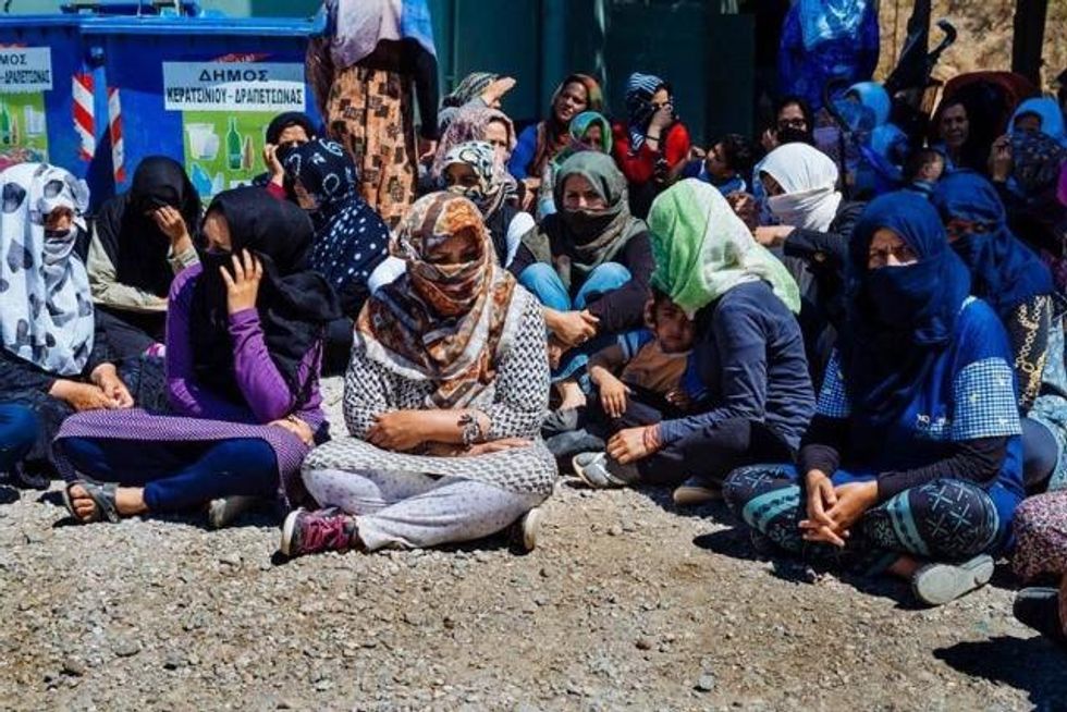 Women at the Schisto refugee camp during the second day of the residents' hunger strike protesting dire conditions. (Photo: Yannis Androulidakis and Agelos Kalodoukas, via AnalyzeGreece)