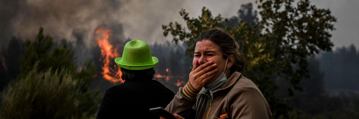 Women cries as wildfire burns in Portugal