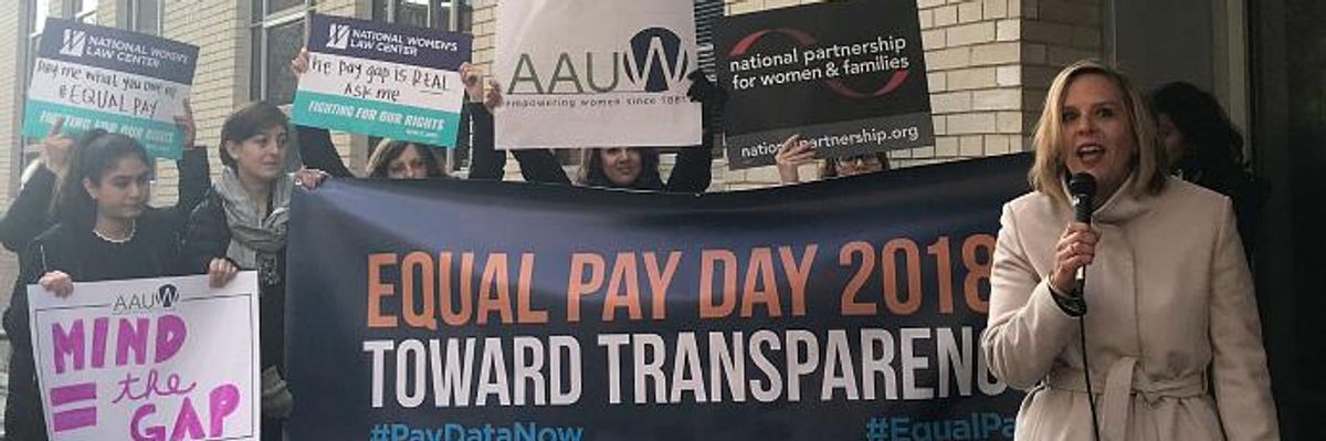 Women protest on Equal Pay Day.