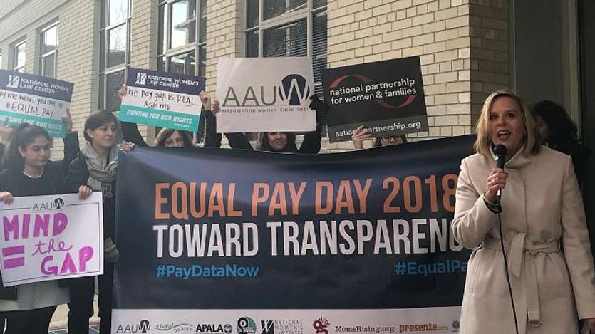 Women protest on Equal Pay Day.