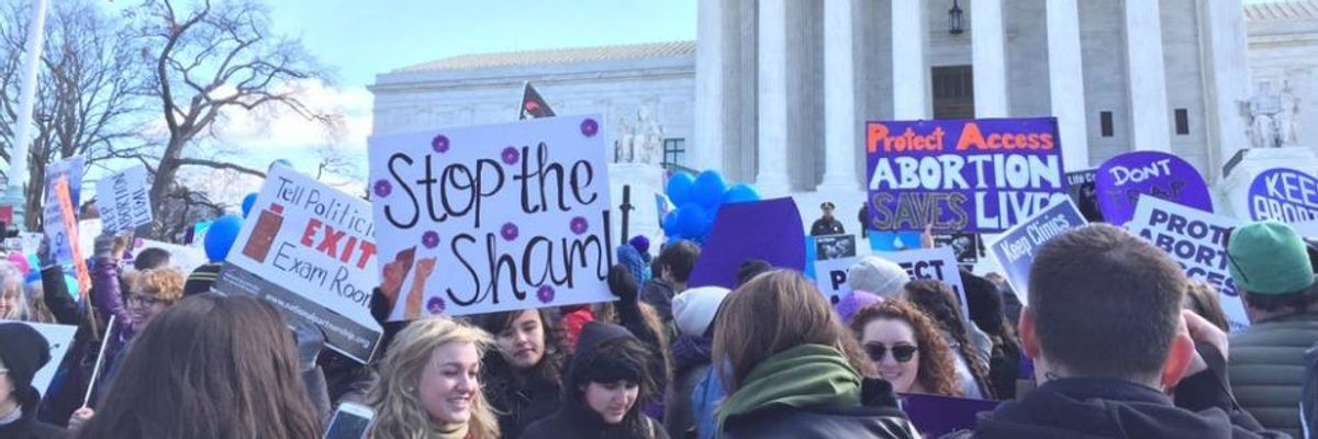 Women protest outside the U.S. Supreme Court against "sham" abortion laws