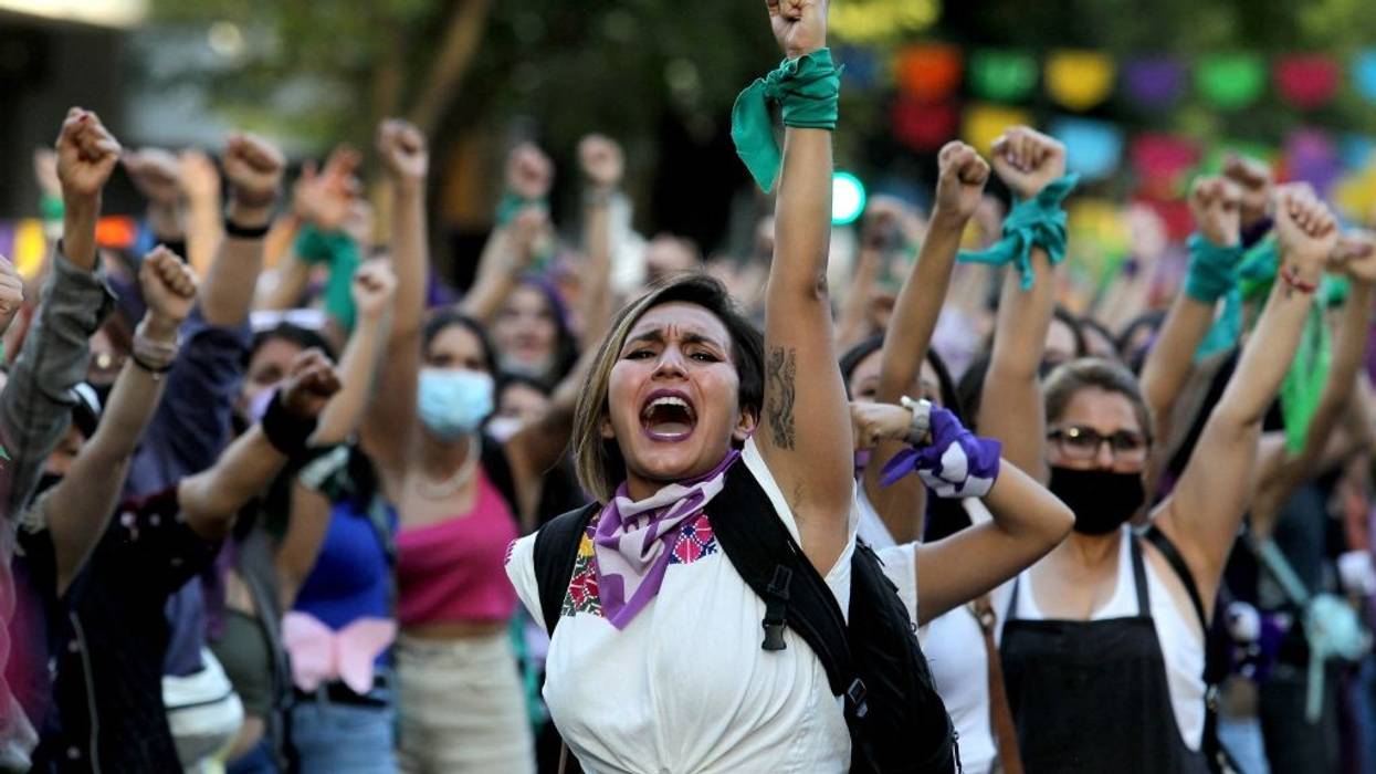 Women raise their fists during a demonstration to mark International Women's Day
