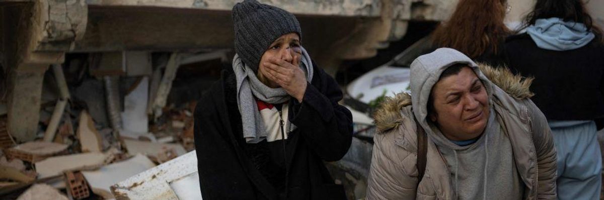 Women react in mourning next to rubble in Hatay, southeastern Turkey, on February 8, 2023, two days after a strong earthquake struck the region