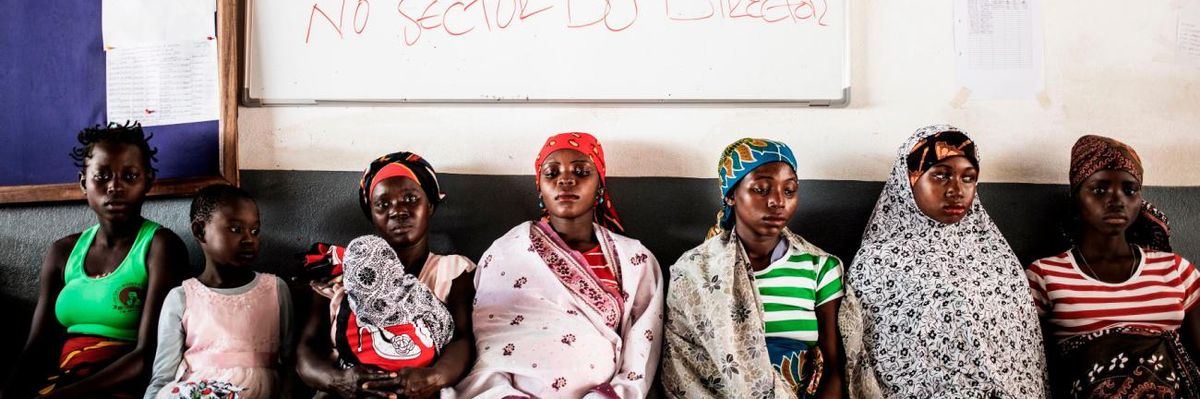 Women wait for medical care at a clinic in Mozambique.