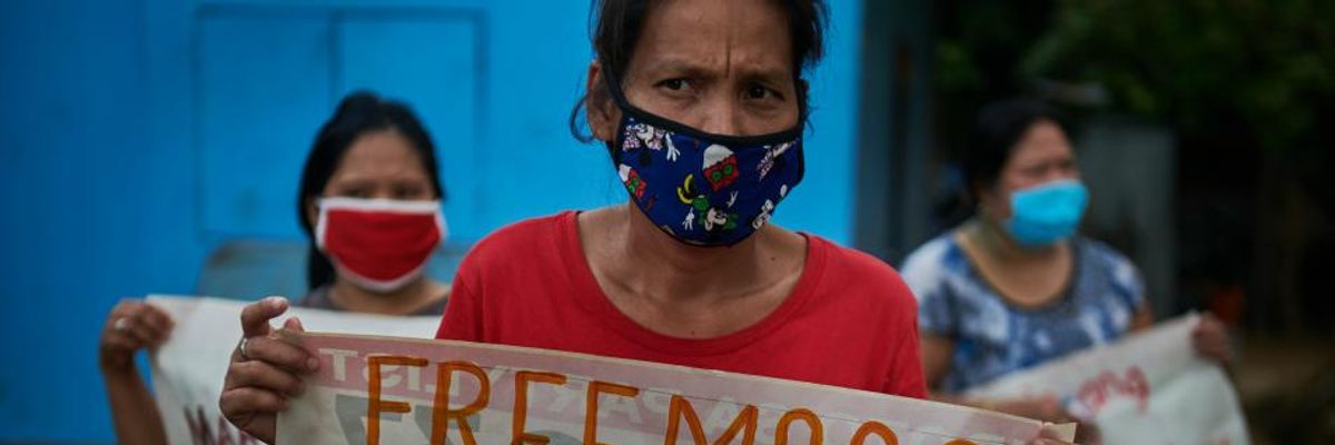 Women workers stage a silent protest while practicing social distancing to mark Labor Day on May 1, 2020 in Quezon City, Philippines
