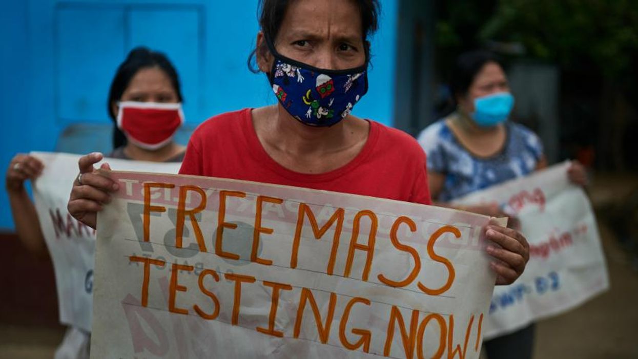 Women workers stage a silent protest while practicing social distancing to mark Labor Day on May 1, 2020 in Quezon City, Philippines
