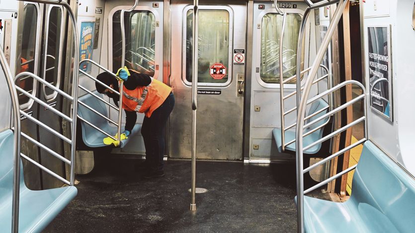 Worker cleans a subway car in New York