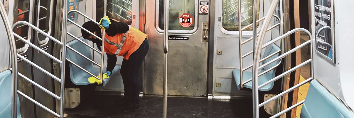 Worker cleans a subway car in New York