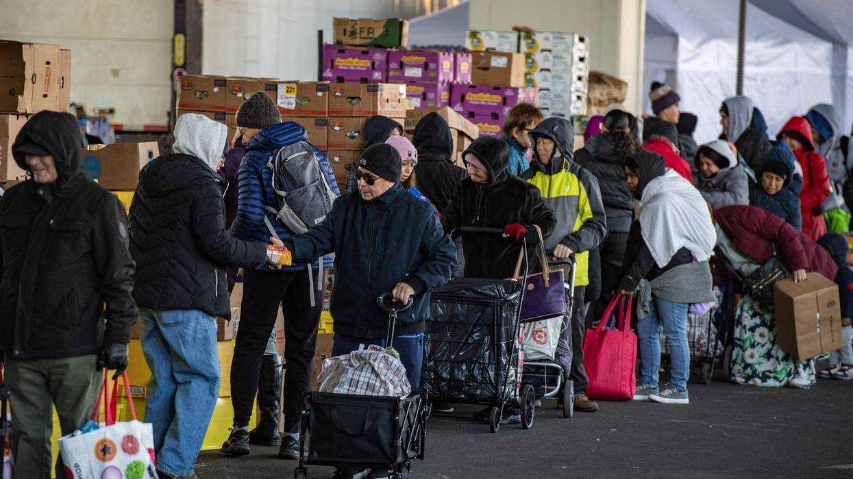 Workers and volunteers hand out food at a food pantry