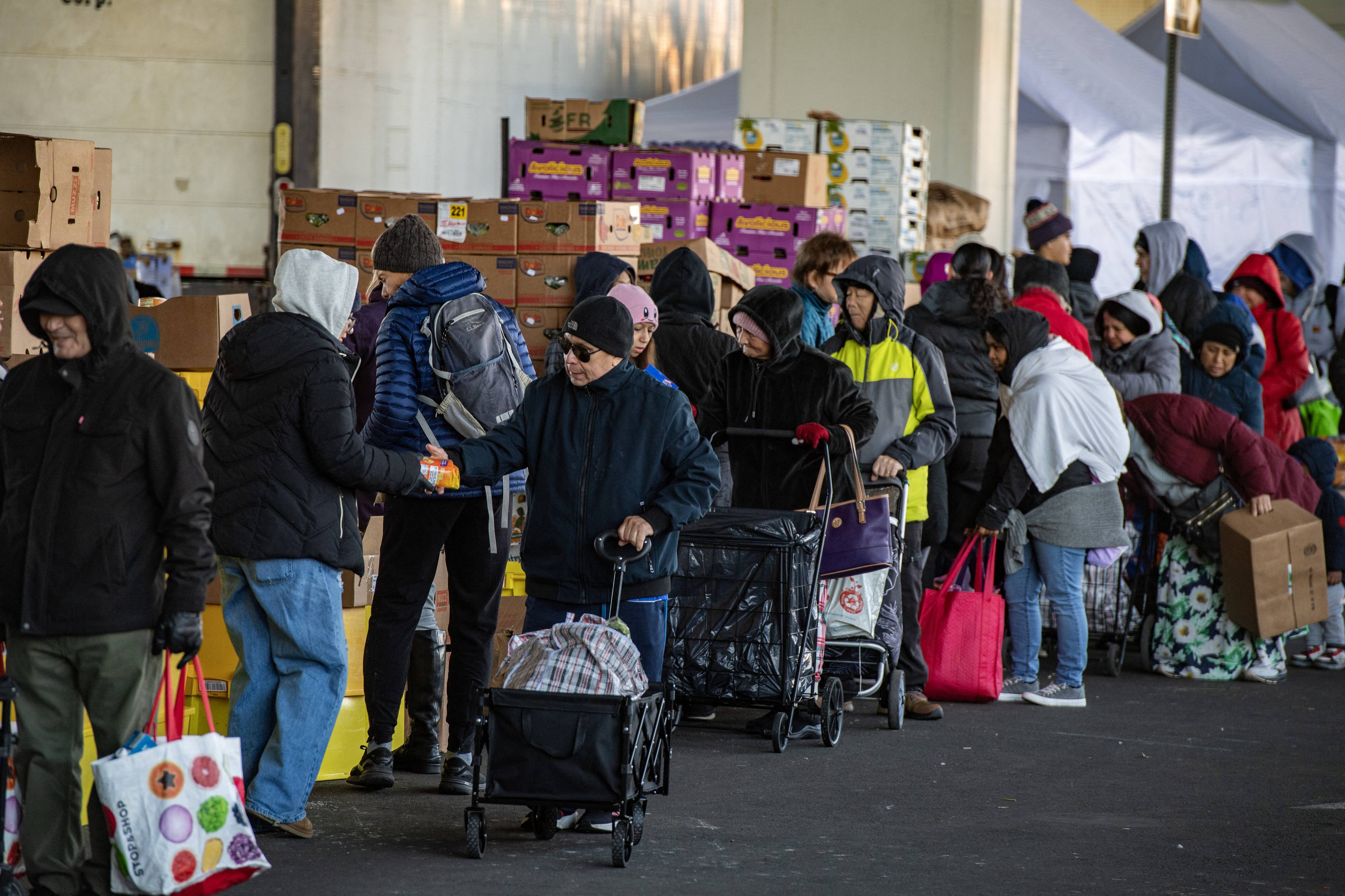 Workers and volunteers hand out food at a food pantry