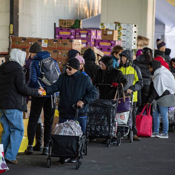 Workers and volunteers hand out food at a food pantry