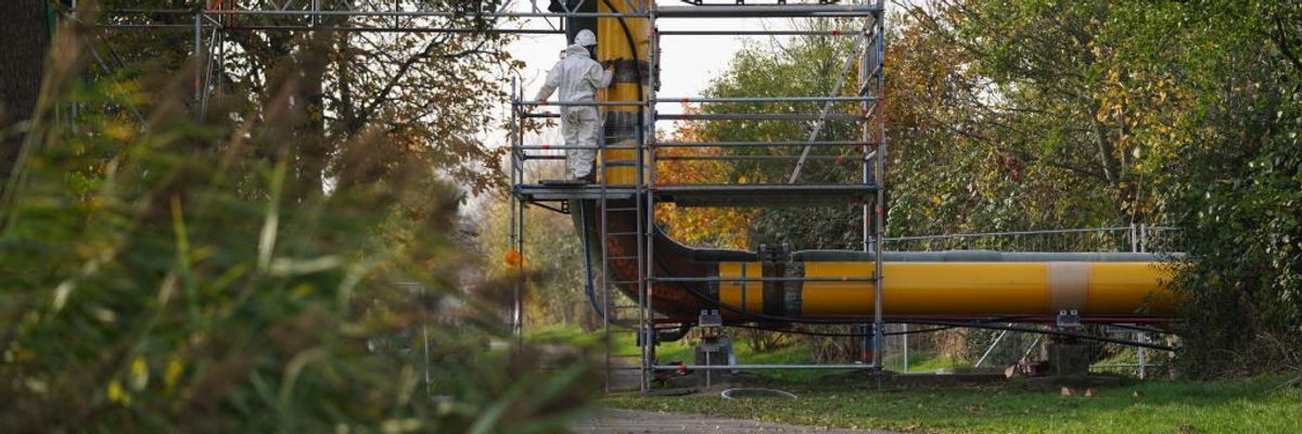Workers assemble pipelines for a planned liquefied natural gas floating terminal