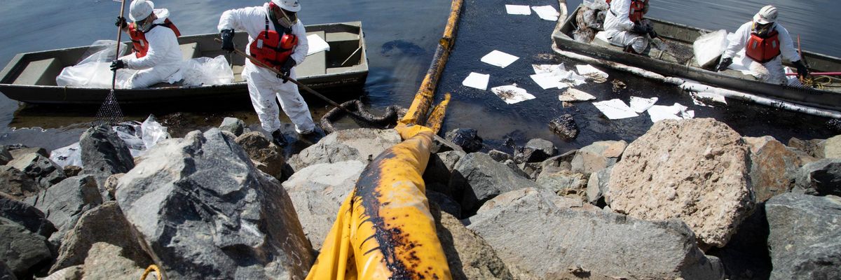 Workers clean up oil