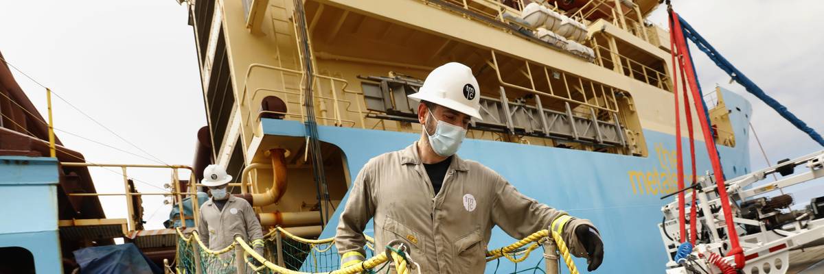 Workers disembark from a research vessel