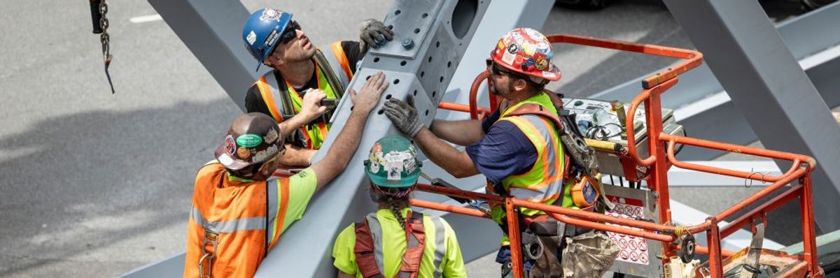 Workers fixing a steelwork on a bridge
