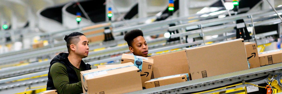 Workers in Amazon fulfilment warehouse
