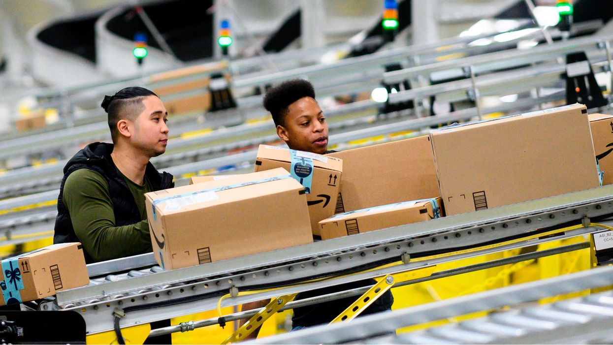 Workers in Amazon fulfilment warehouse