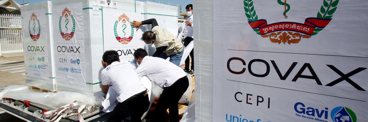 Workers move packages of Covid-19 vaccines