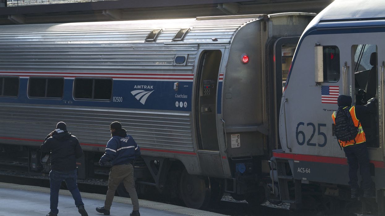 Workers on an Amtrak platform.