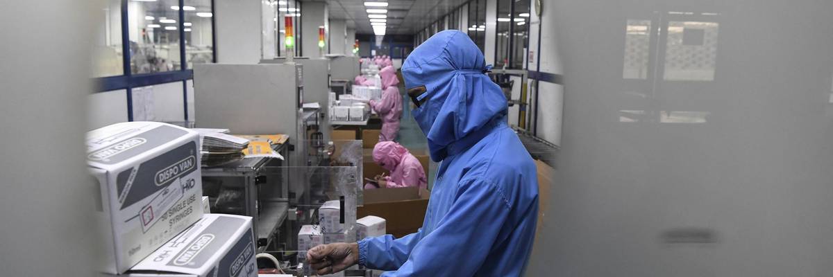 Workers pack syringes at a factory in India.