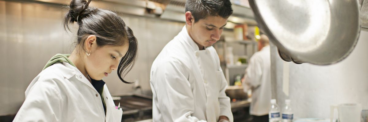 Workers prepare appetizers in a restaurant kitchen in Portland, Oregon.