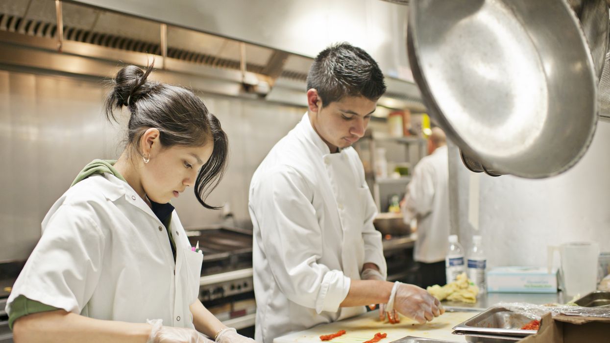 Workers prepare appetizers in a restaurant kitchen in Portland, Oregon.