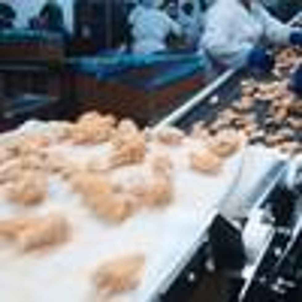 Workers process meat at a Tyson Foods chicken plant. (Photo: Gregory Smith/Corbis via Getty Images)